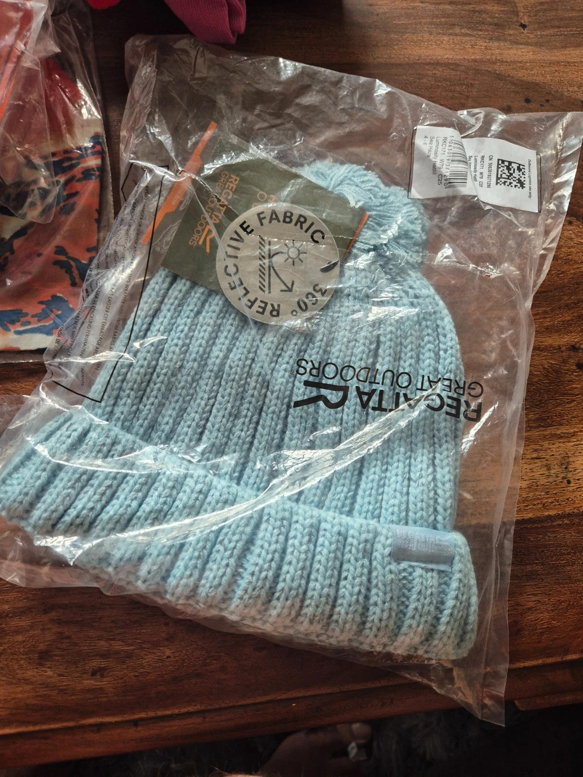 Regatta light blue baby hat with ribbed knit design and logo tag.