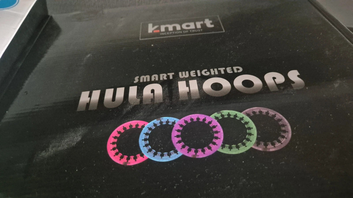 Kmart black and pink hula hoop with smooth surface and lightweight design.