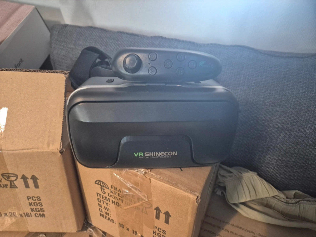 VR Shinecon black virtual reality headset with wireless Bluetooth remote controller.
