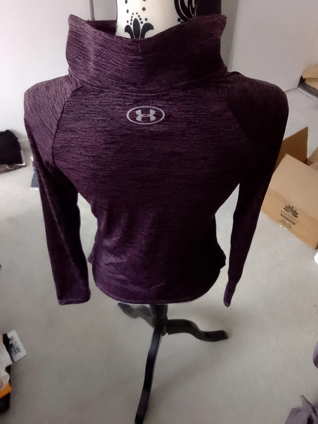 Under Armour black and purple zip-up jacket with logo and athletic design.