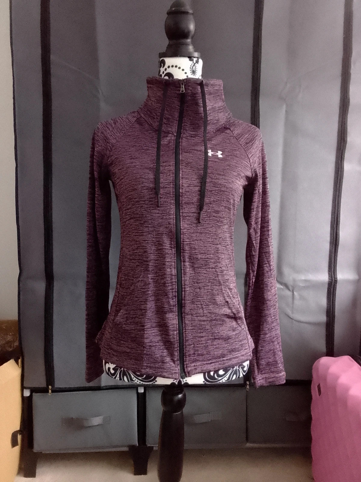 Under Armour black and purple zip-up jacket with logo and athletic design.