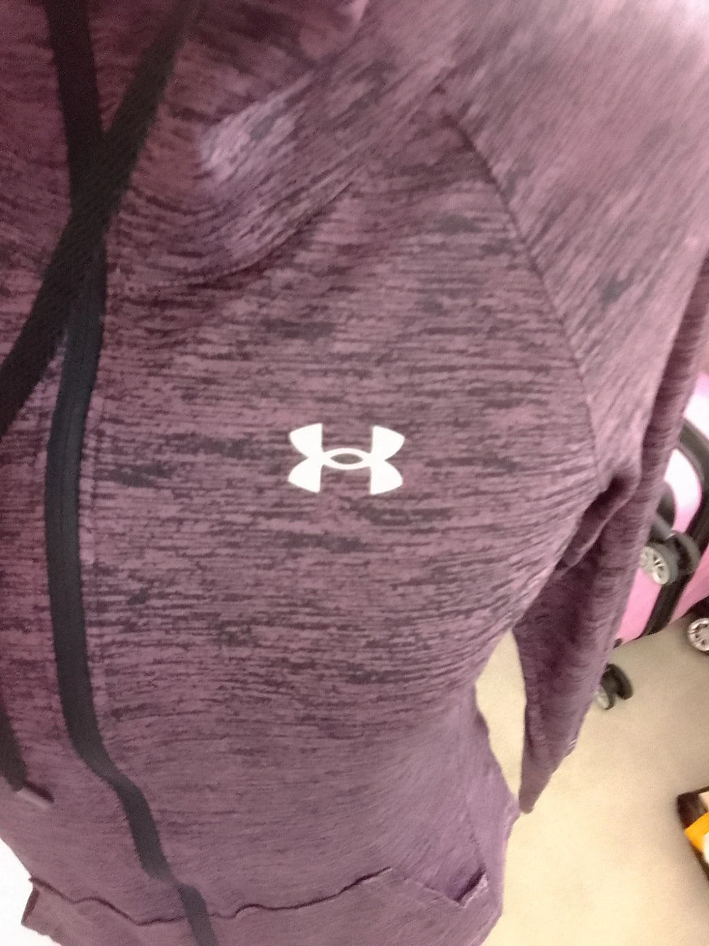 Under Armour black and purple zip-up jacket with logo and athletic design.