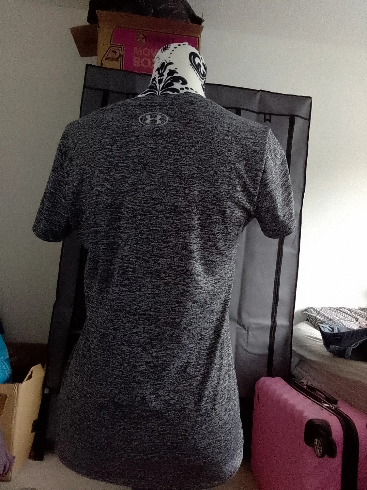 Under Armour black and grey pocket t-shirt with logo, suitable for active wear.