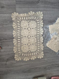 Handmade Beauty cream doilies with elegant openwork floral lace pattern and scalloped edges.