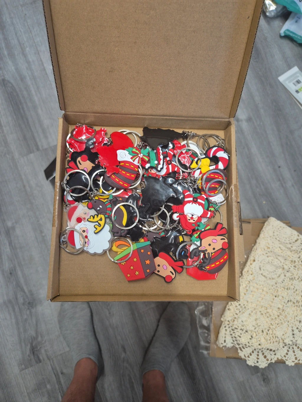 Accessories multi keychains in festive designs, packaged in three boxes.