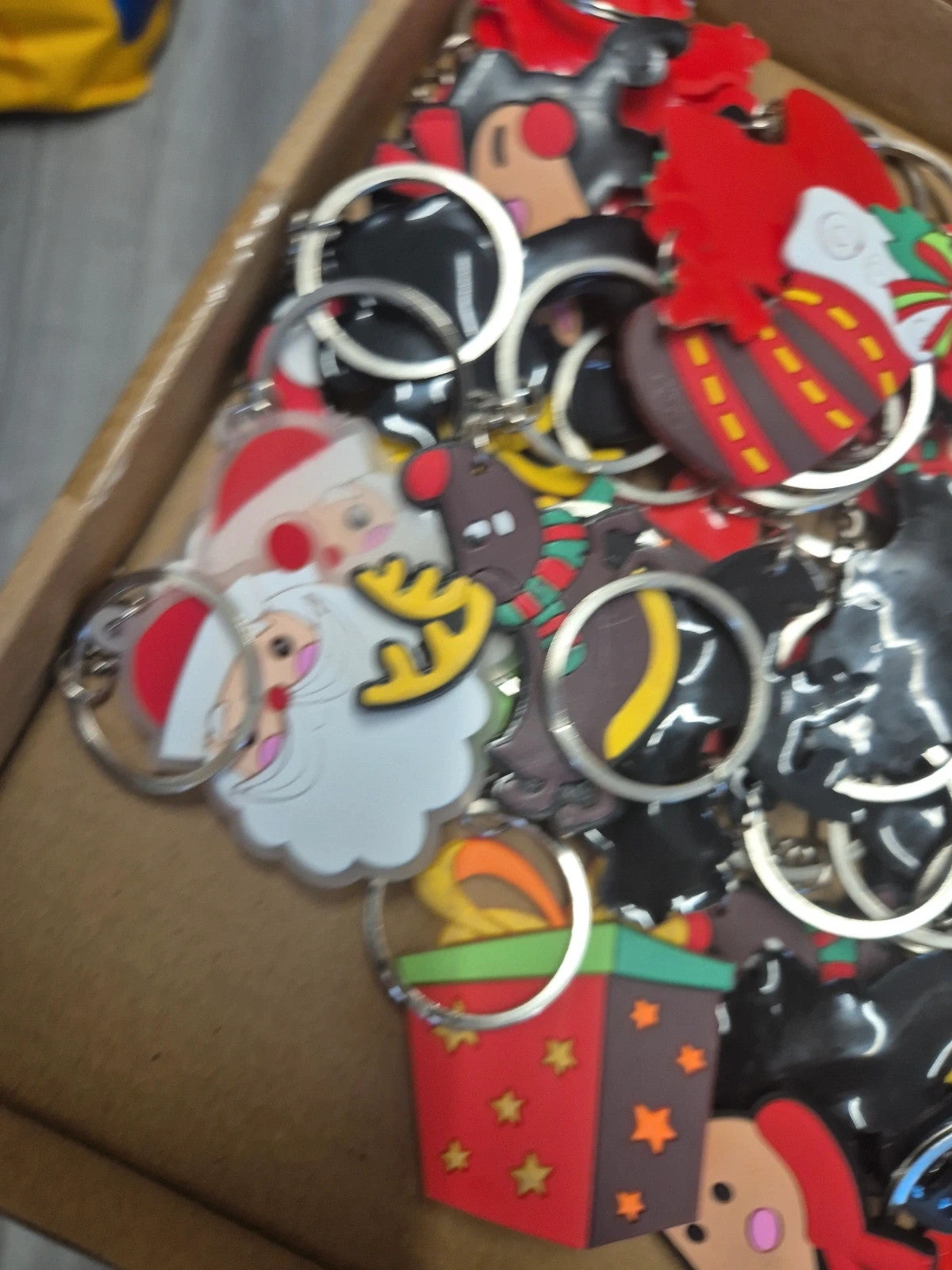 Accessories multi keychains in festive designs, packaged in three boxes.