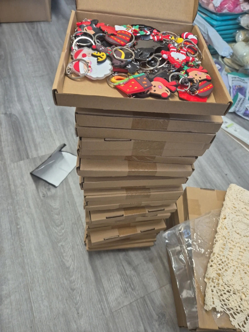 Accessories multi keychains in festive designs, packaged in three boxes.