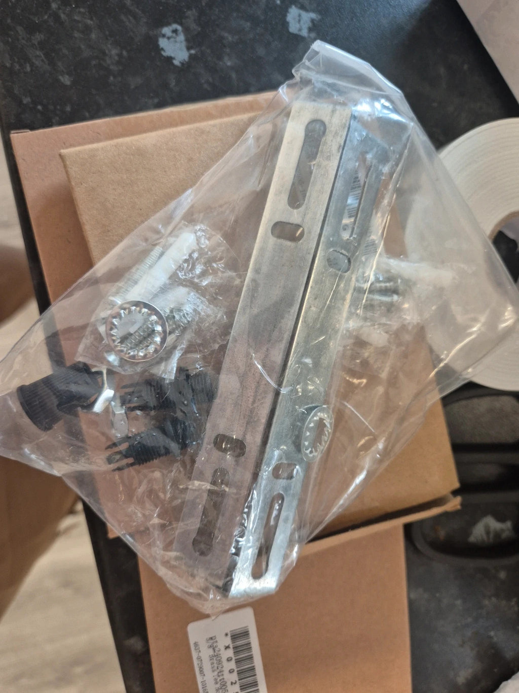 Accessories silver ceiling light bracket kit with metal crossbar, screws, and wall plugs.