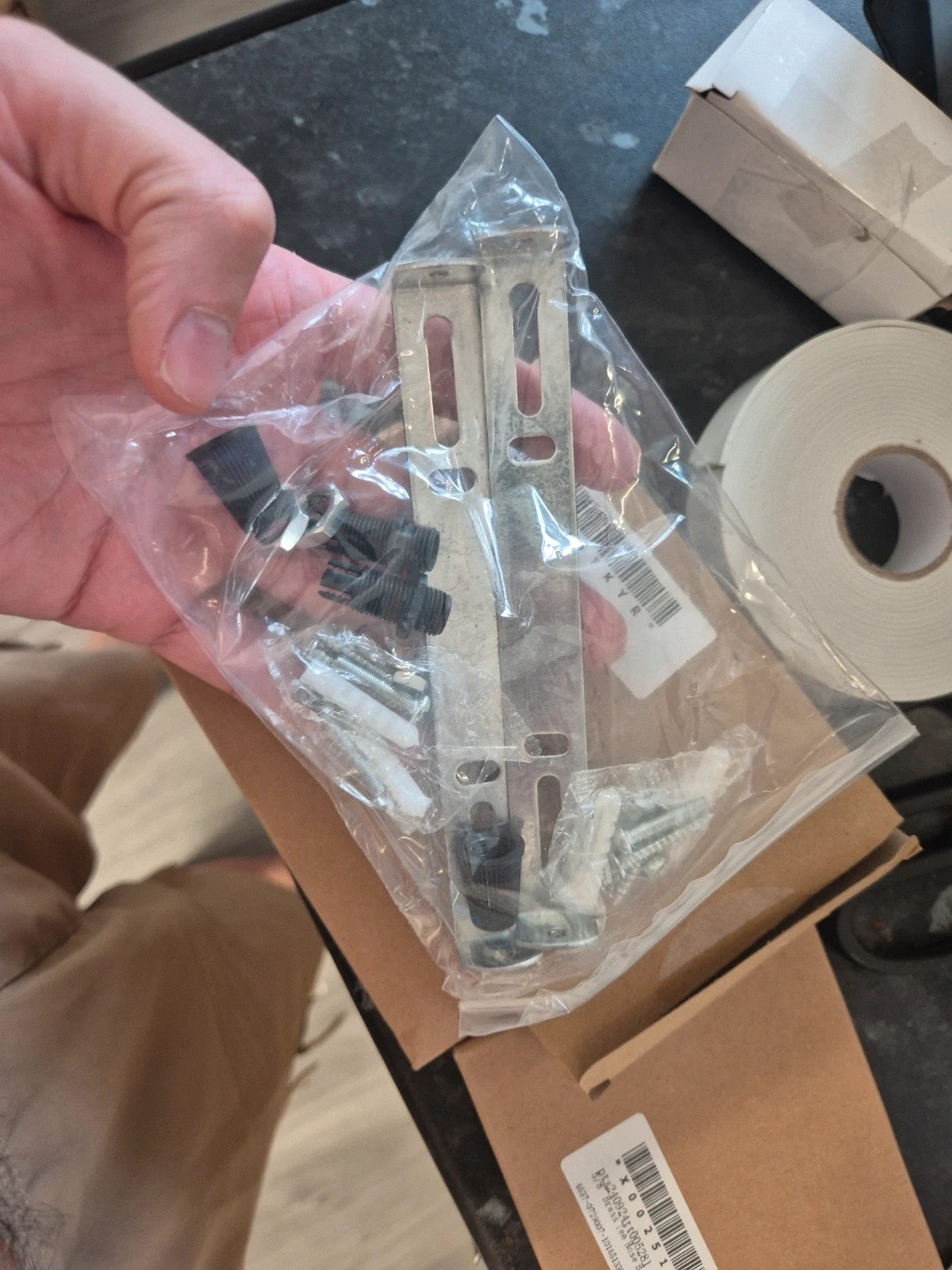 Accessories silver ceiling light bracket kit with metal crossbar, screws, and wall plugs.