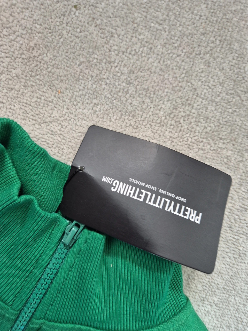 PrettyLittleThing green knit jumper with tags, featuring a soft texture and casual style.