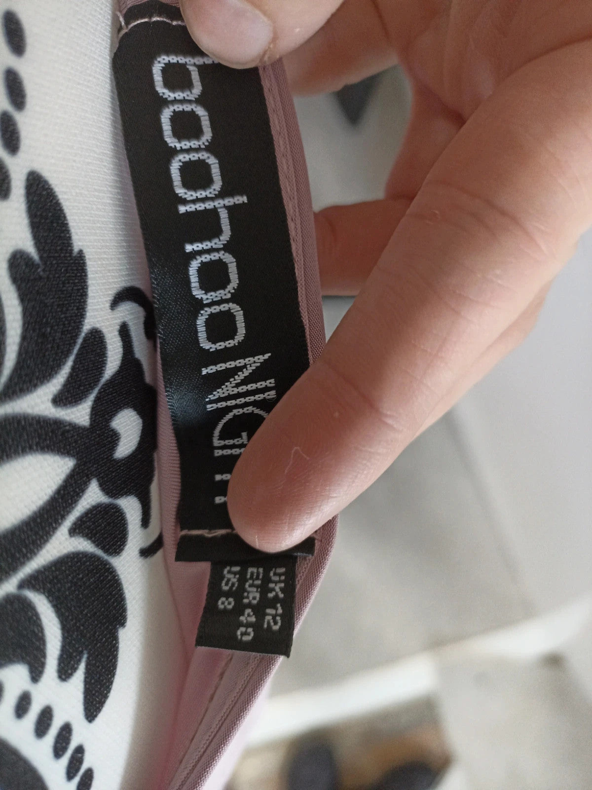 Boohoo pink bandage dress size 12, form-fitting design, new without tags.