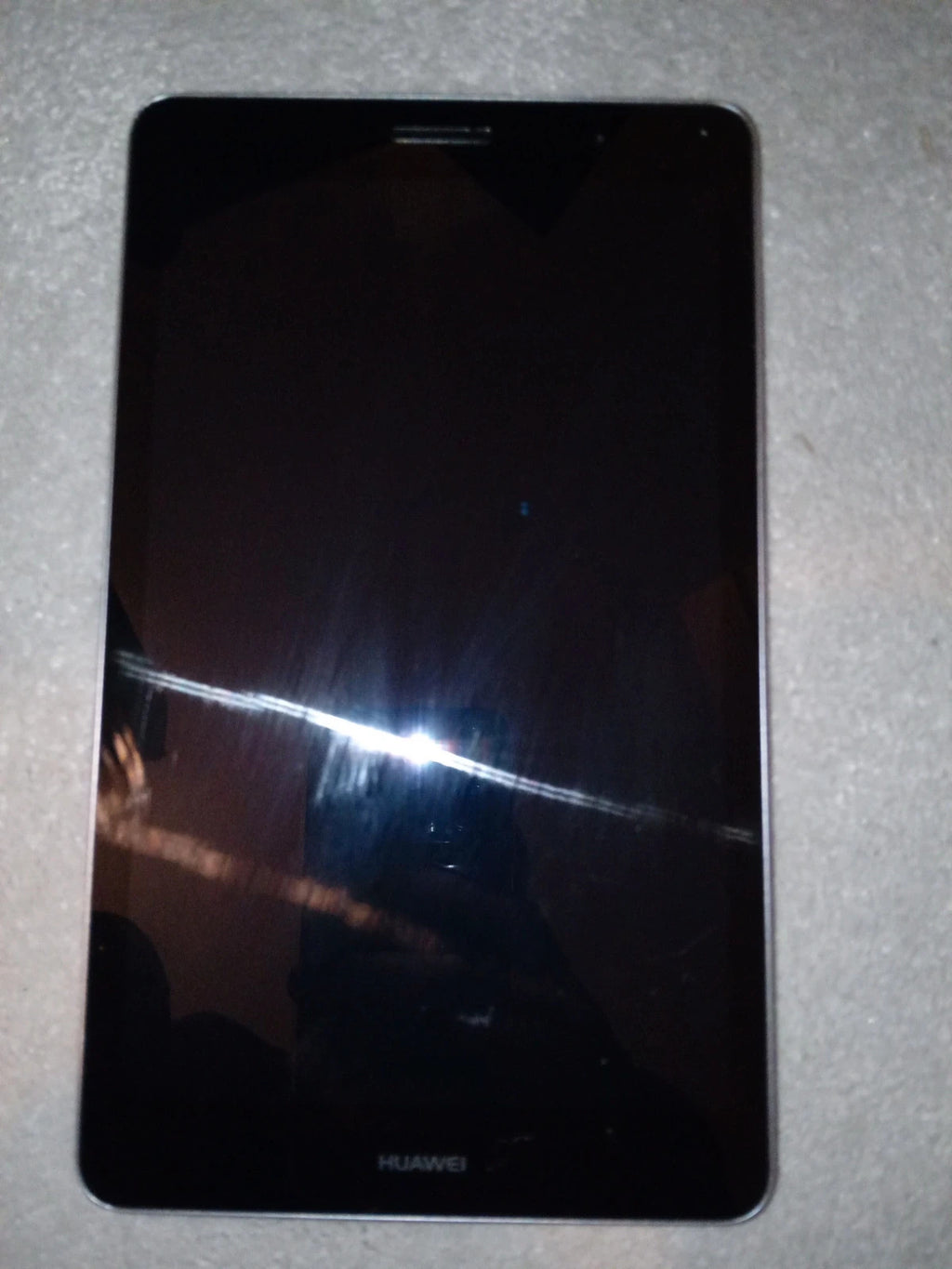 Huawei grey MediaPad T3 tablet with sleek design and 16GB storage.