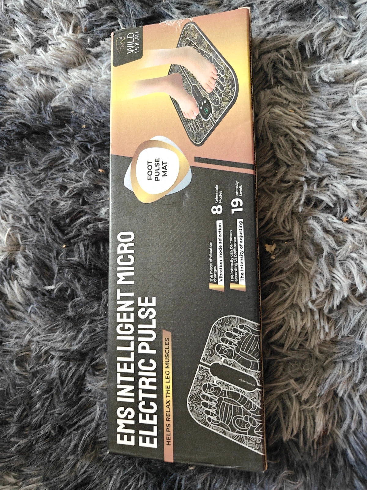 EMS black electric massager in box with sleek design and user-friendly interface.