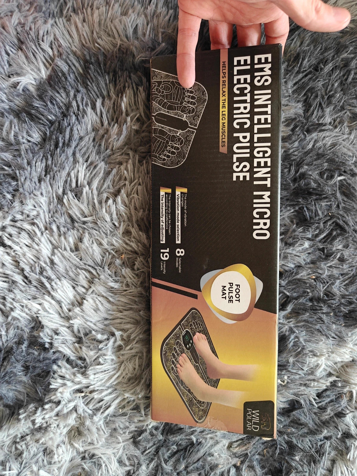 EMS black electric massager in box with sleek design and user-friendly interface.