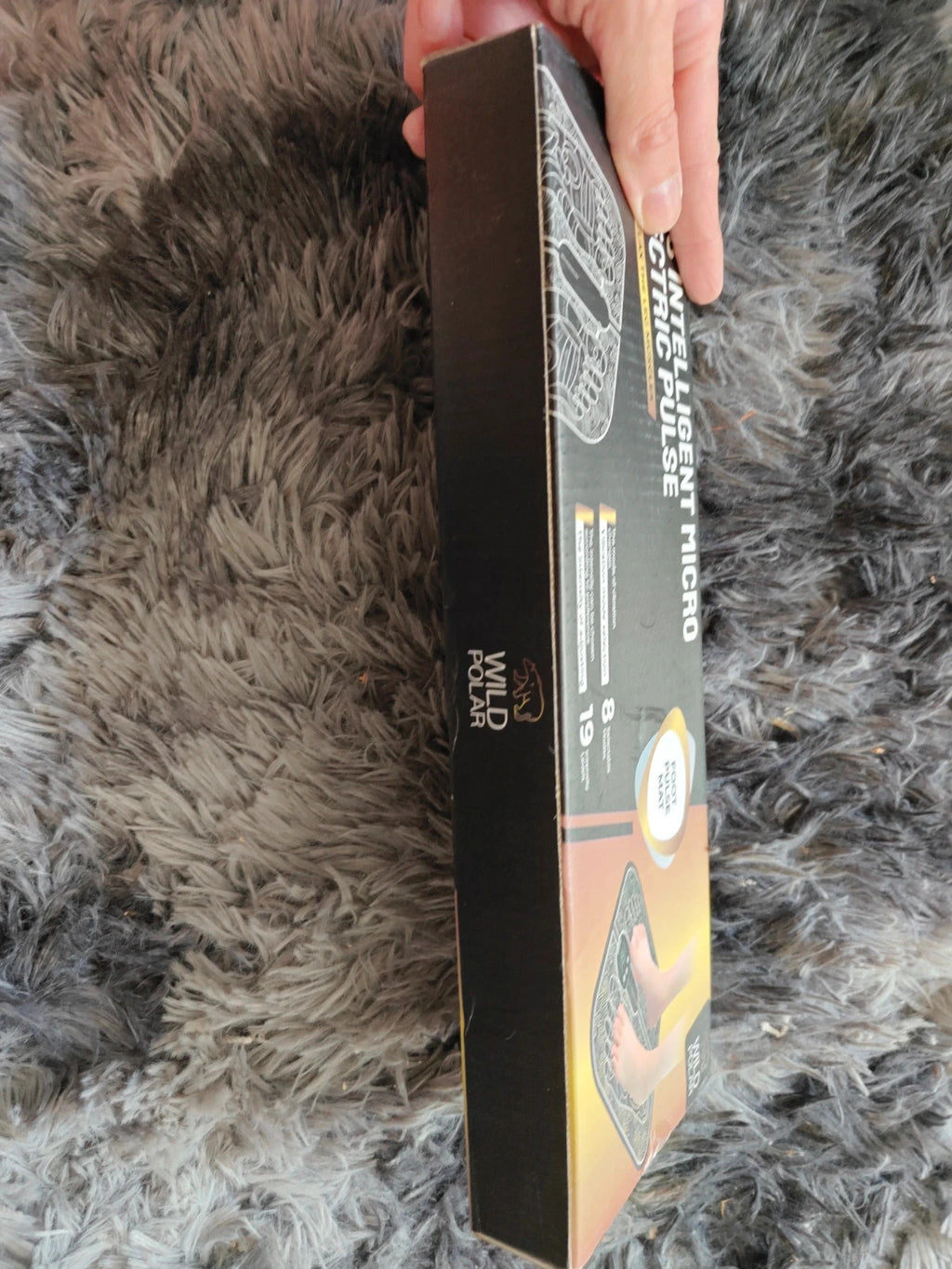 EMS black electric massager in box with sleek design and user-friendly interface.