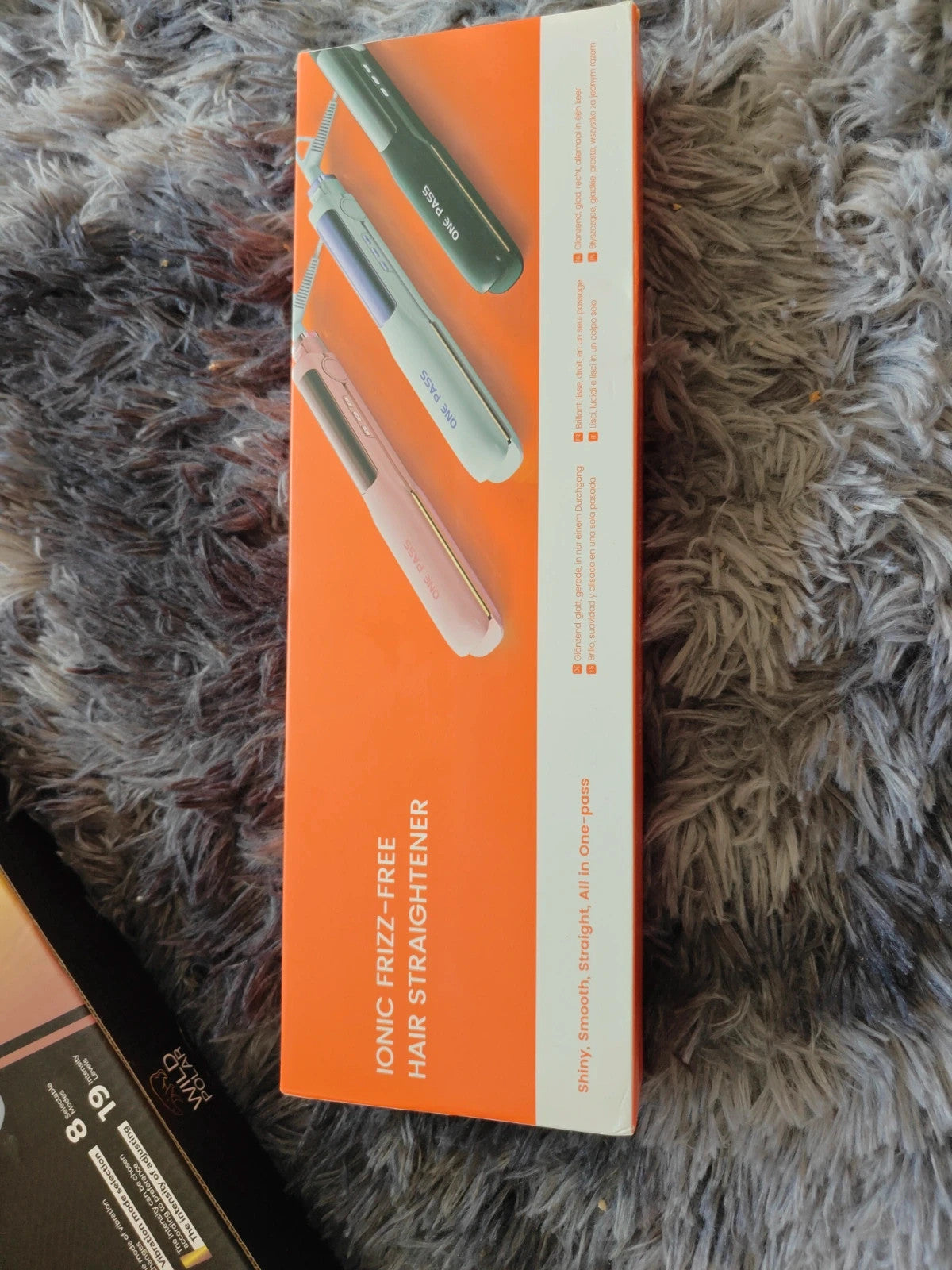Iconic black hair straighteners in box, sleek design with modern finish.