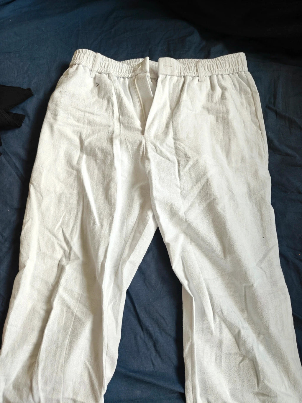 LV Clothing white trousers size medium with clean design and no visible logos.