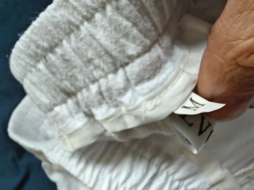 LV Clothing white trousers size medium with clean design and no visible logos.