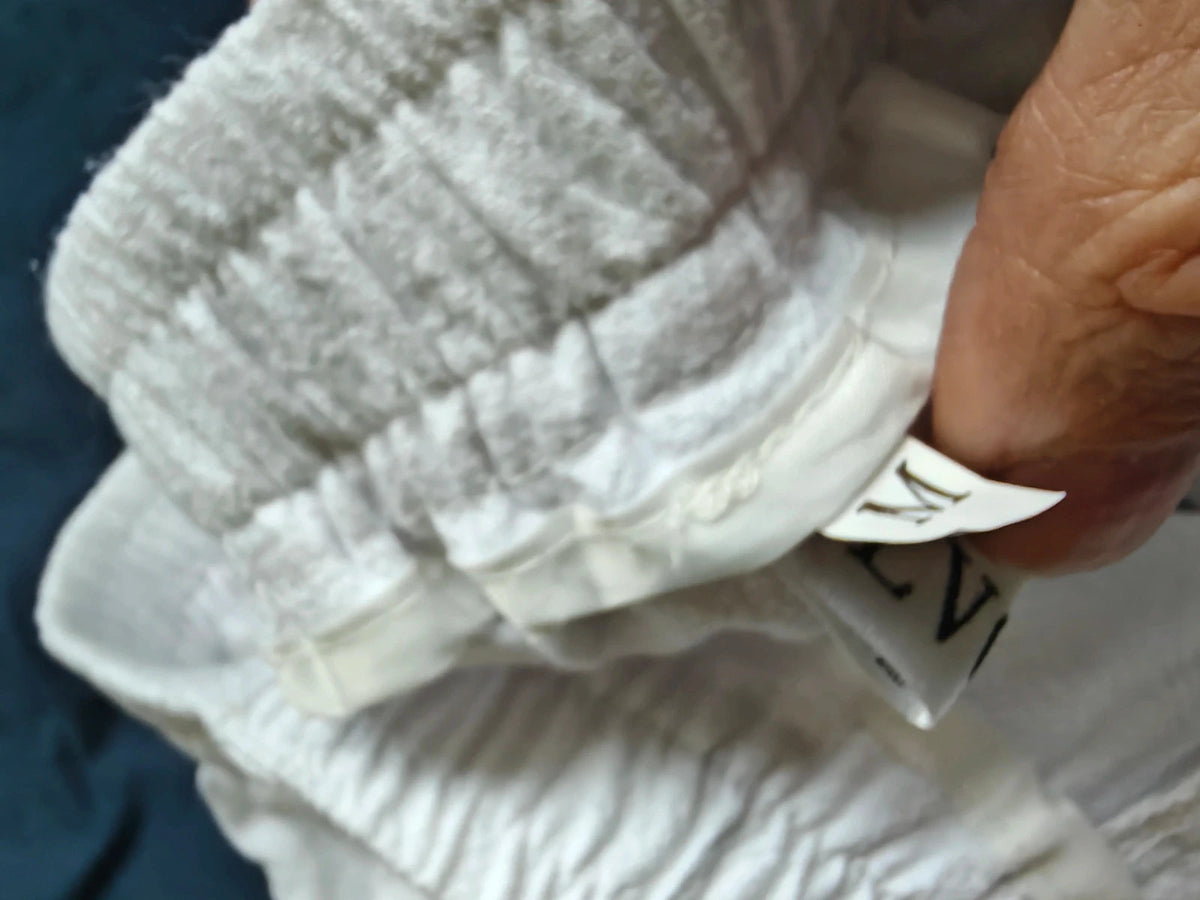 LV Clothing white trousers size medium with clean design and no visible logos.