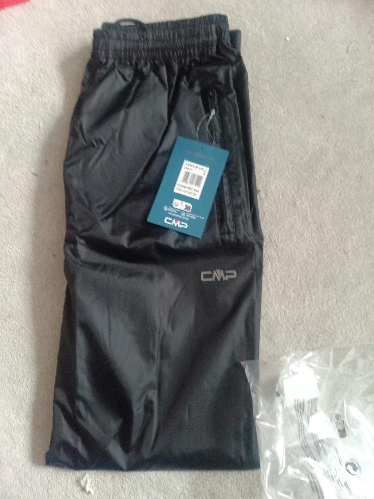 CMP black rain trousers size XS with tags, sleek design and lightweight material.