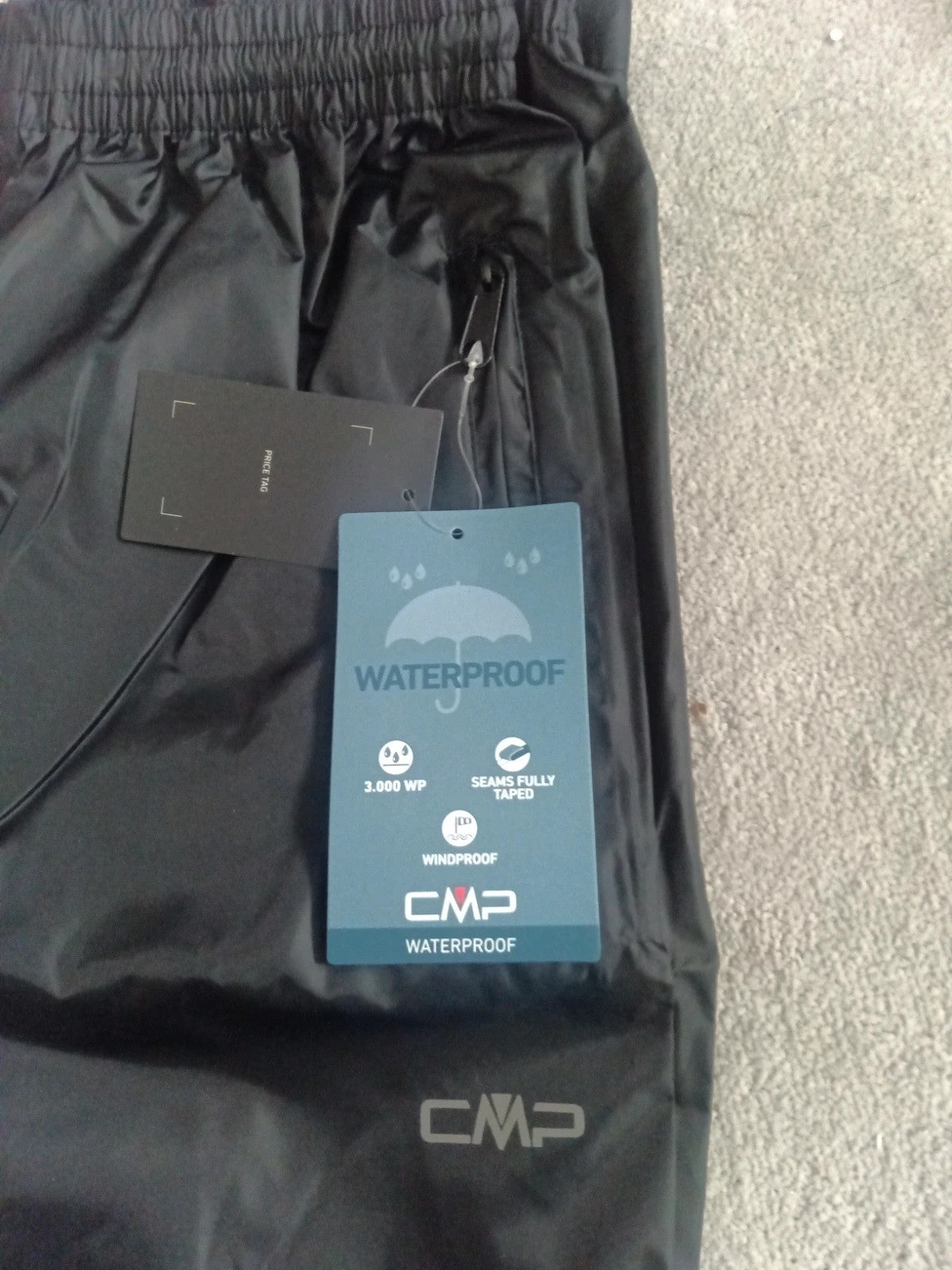 CMP black rain trousers size XS with tags, sleek design and lightweight material.