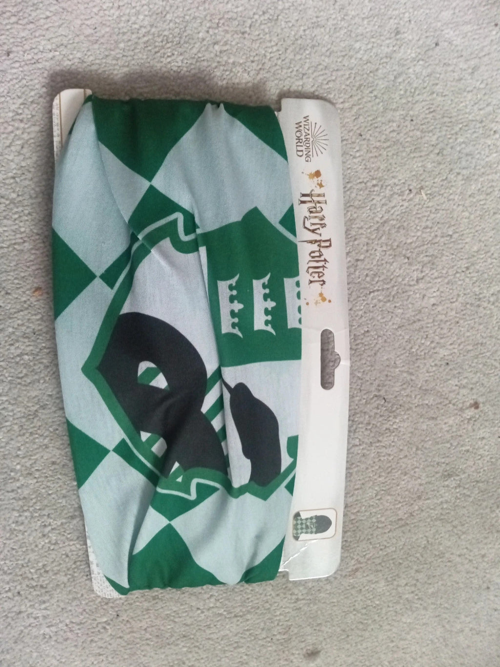 Harry Potter green and white face covering with printed logo and new with tags.