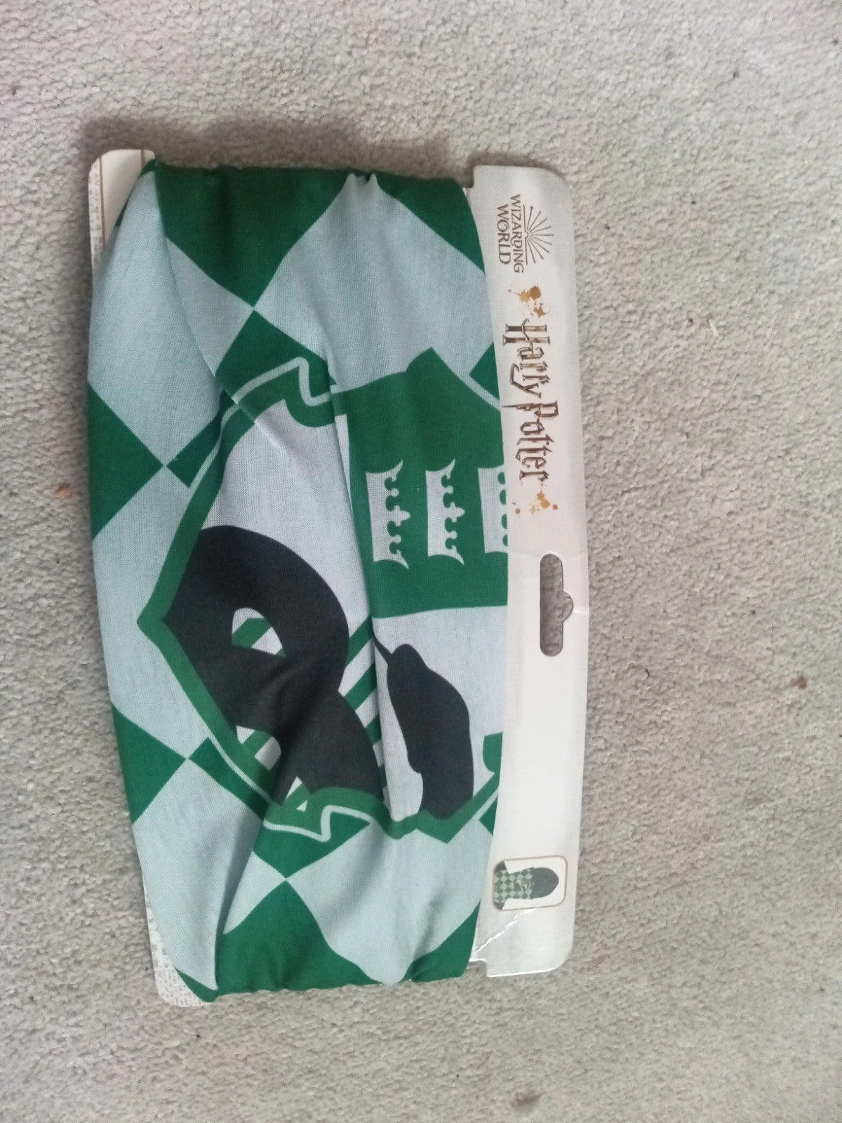 Harry Potter green and white face covering with printed logo and new with tags.