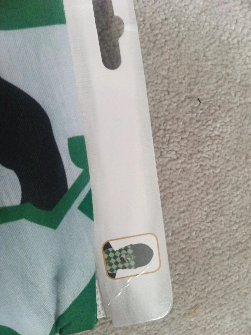 Harry Potter green and white face covering with printed logo and new with tags.