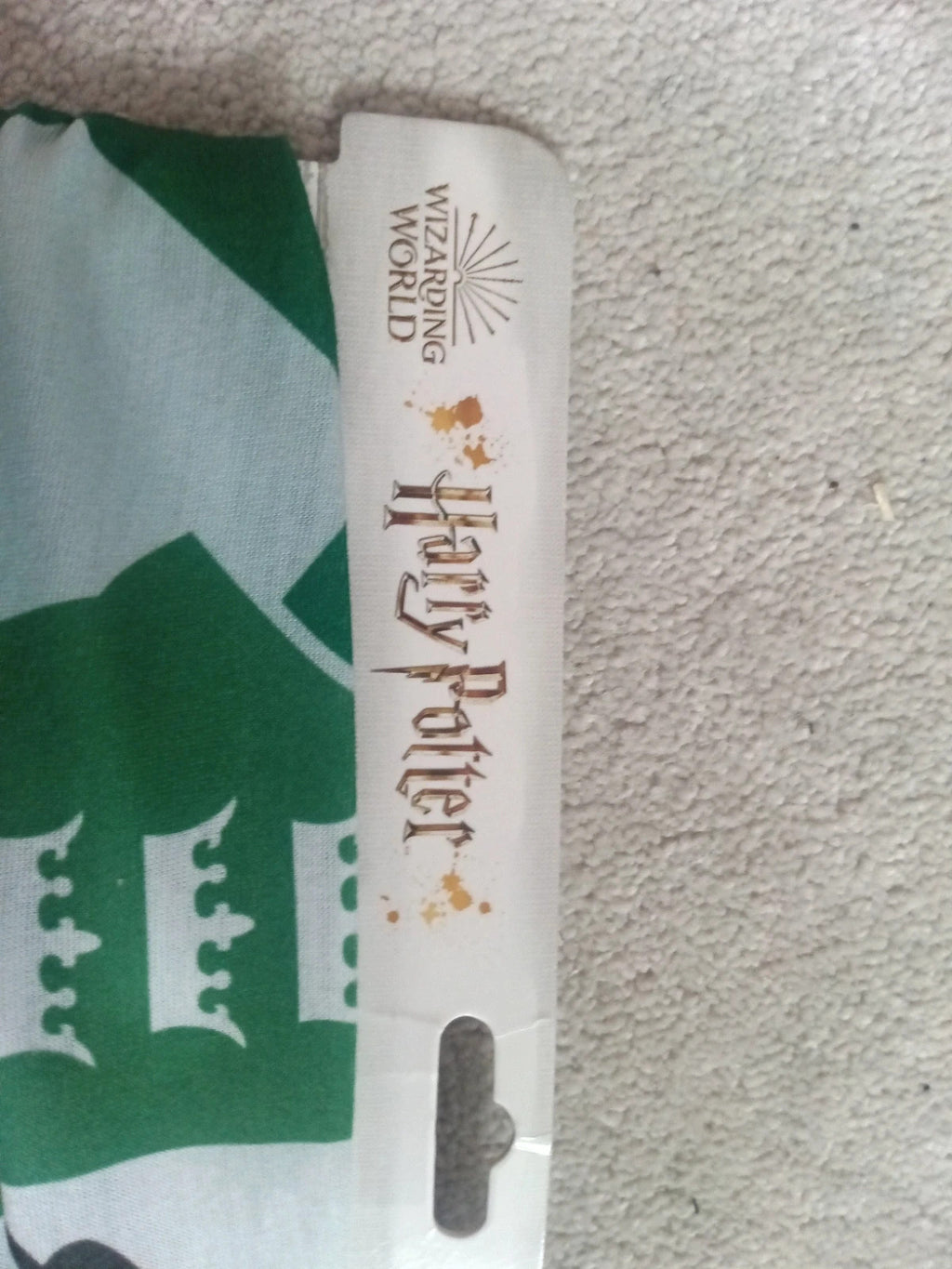 Harry Potter green and white face covering with printed logo and new with tags.